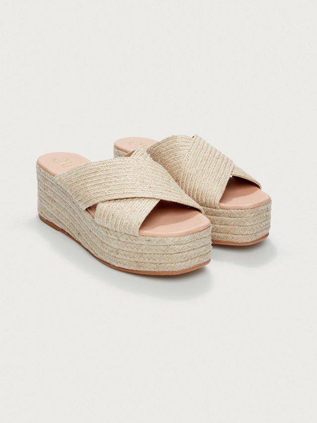 the sandals are made from woven material and have a braid on the sole